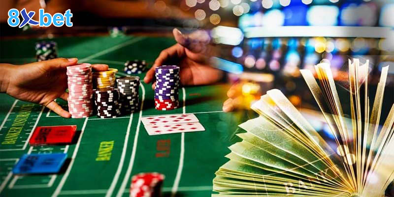 Người chơi đặt chồng chip lên ô Banker và Player trên bàn baccarat 8xbet màu xanh